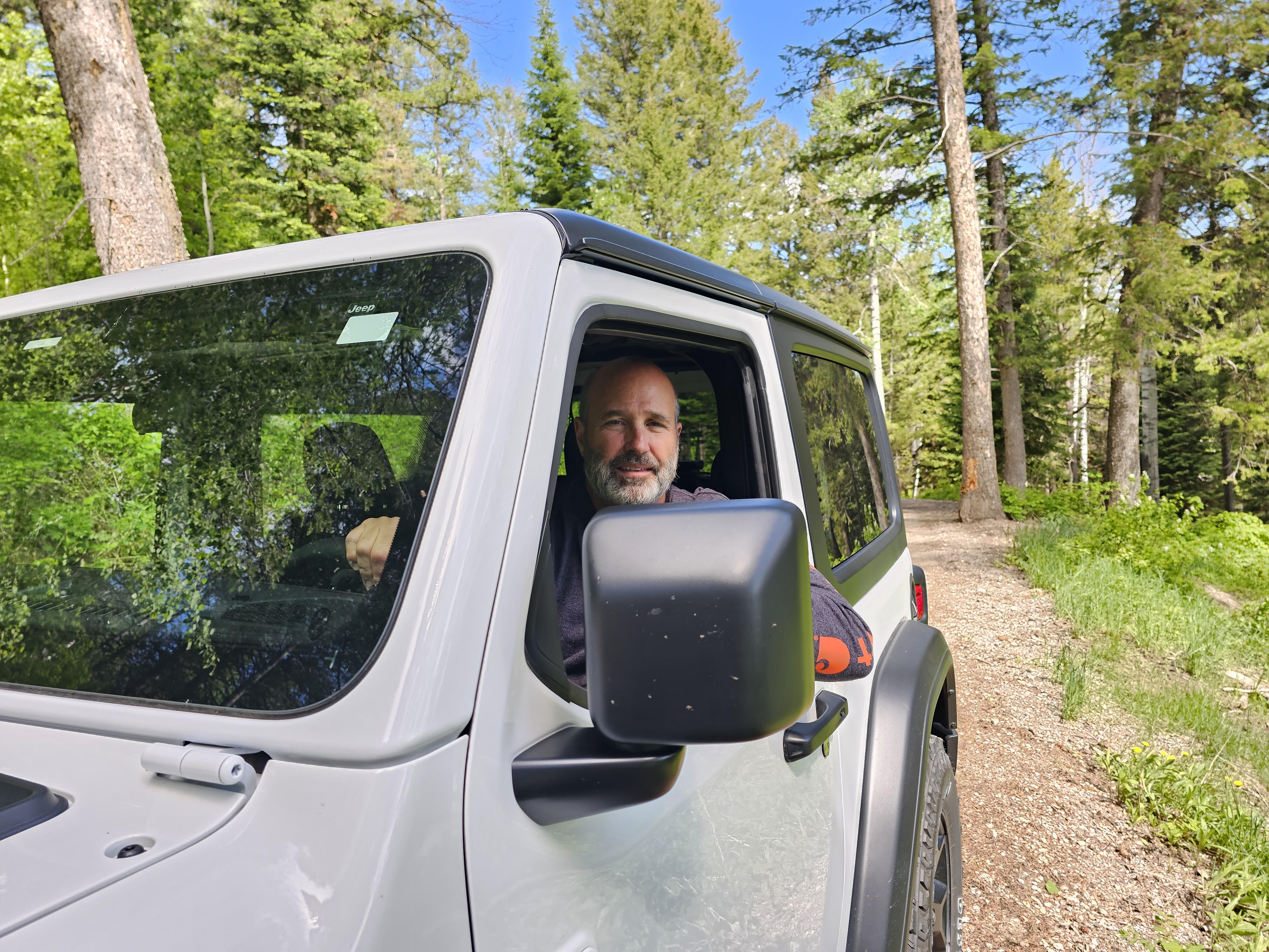 David driving a Jeep on a forest trail
